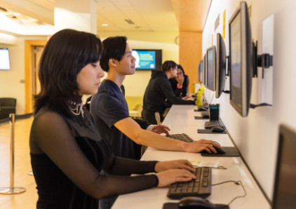 Oakton College students use the computers in the Enrollment Center.