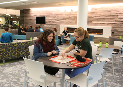 Two students playing scrabble in the Student Center.