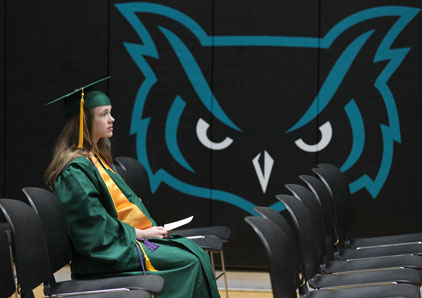 Girl sits at graduation anticipating future
