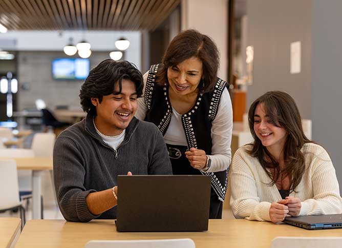 Two Oakton students meeting with a professor.